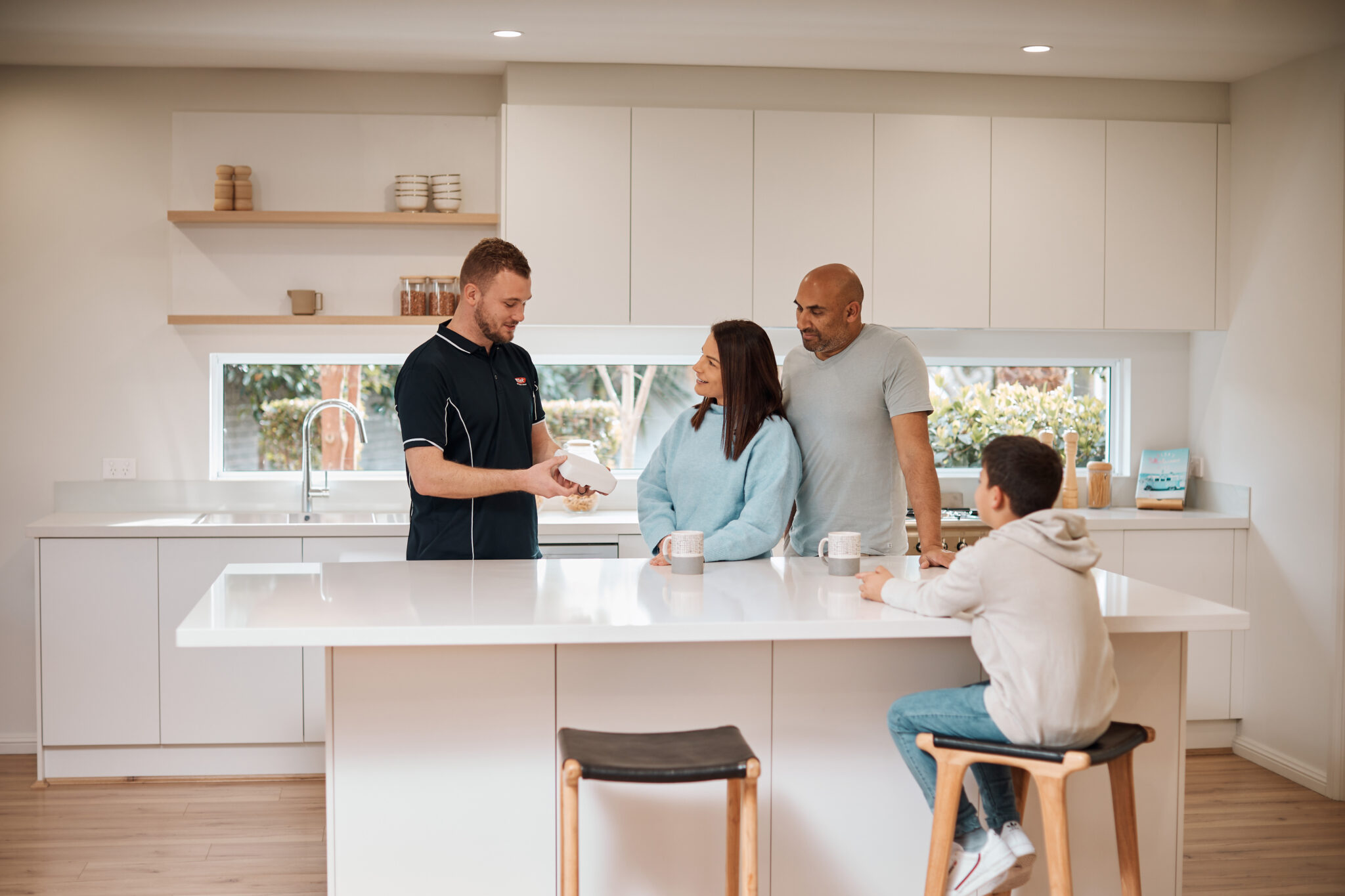 Flick technician explaining Flick's home protection plans to homeowners